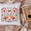 White linen pillow, cushion Mockup on plaid. Inrerior photo Romantic swans cross stitch design displayed on decorative pillow
