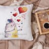 finished cross stitch artwork featuring a cute romantic cat with colorful hearts on pillow case