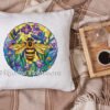 Stained glass bee cross stitch design displayed on decorative pillow