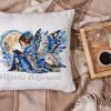 Elf girl and barn own cross stitch design displayed on decorative pillow