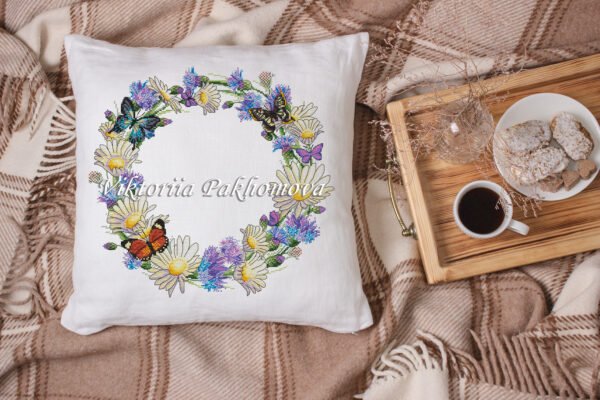 Decorative pillow with cornflower wreath and butterfly cross stitch embroidery