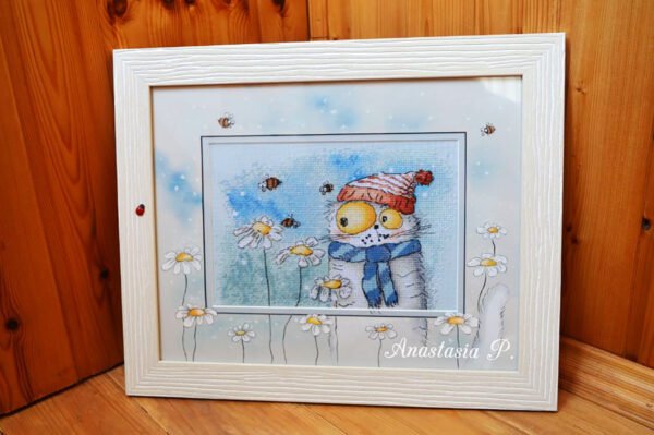 7zjjoWpqDag Framed cross stitch artwork featuring a whimsical chamomile cat with bees and floral details in soft bright colors