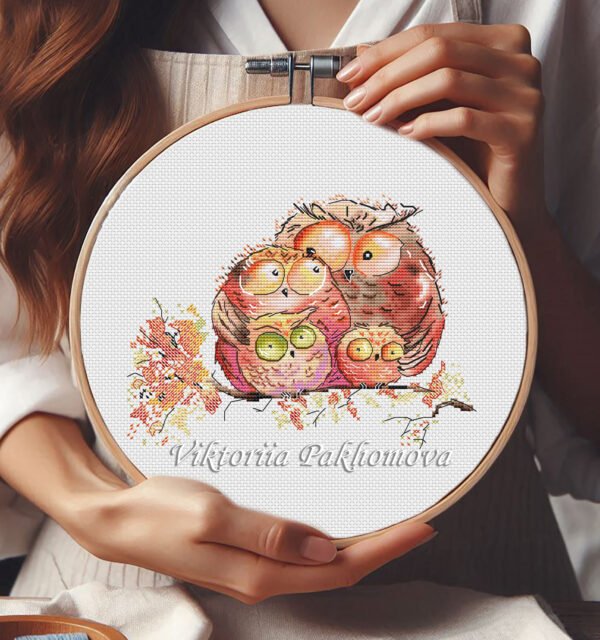Autumn Owls Family cross stitch pattern displayed in a wooden embroidery hoop with warm fall colors