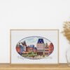 Framed cross stitch of Trier Germany cityscape with colorful European buildings, detailed urban embroidery