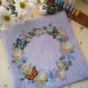 Finished embroidery with cornflower wreath and butterfly cross stitch