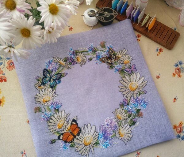 Finished embroidery with cornflower wreath and butterfly cross stitch