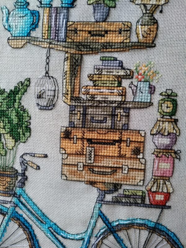 close‑up of bicycle and books embroidery with bright colors