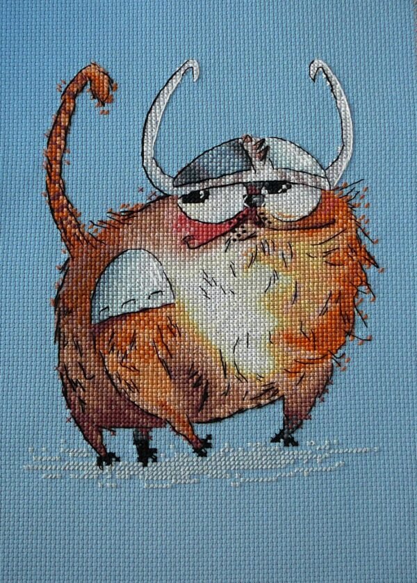 cross stitch artwork of a Viking‑themed ginger cat with expressive details and warm colors.