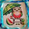 Watermelon owl cross stitch displayed in hoop with tropical summer decor items