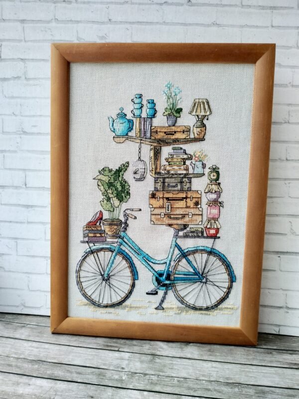 cute bicycle embroidery with stacked books and cozy objects framed