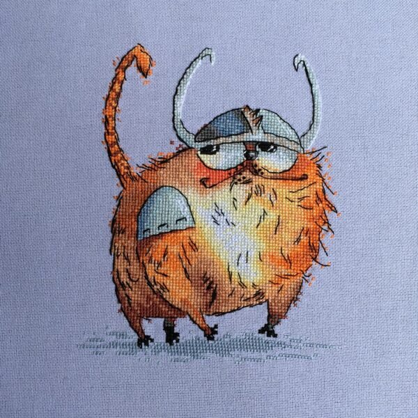 cross stitch artwork of a Viking‑themed ginger cat with expressive details and warm colors.