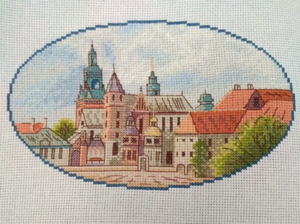 Krakow city cross stitch artwork with historic European buildings, vibrant architecture embroidery