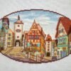 Rothenburg city cross stitch artwork with cobblestone street and half‑timbered houses, detailed European embroidery