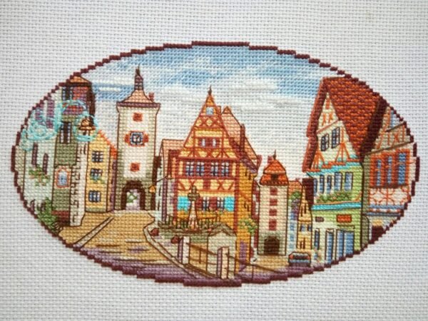 Rothenburg city cross stitch artwork with cobblestone street and half‑timbered houses, detailed European embroidery