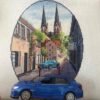 Finished embroidery of Neuruppin Germany cross stitch pattern with European cityscape and blue car