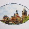 il_1588xN.2998995535_g592 Prague Charles Bridge cross stitch displayed with cozy decor, vibrant European travel embroidery