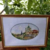 Framed Kyiv city cross stitch artwork with Andriyivskyi Descent and historic houses, vibrant Ukrainian embroidery