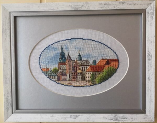 Framed Krakow city cross stitch artwork with historic European buildings, vibrant architecture embroidery