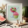 mock up frame standing on a linen table with watermelon nearby framed cute dessert embroidery with colorful ice cream and cupcake