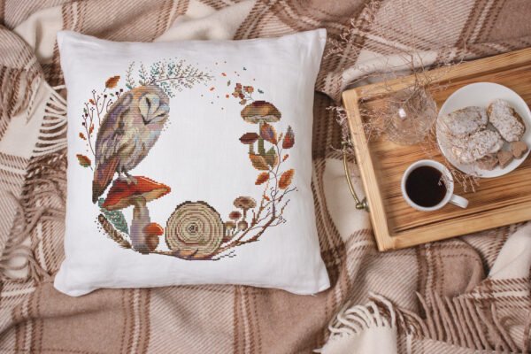 Barn owl cross stitch pillow with mushrooms and leaves, warm rustic fall decor setup