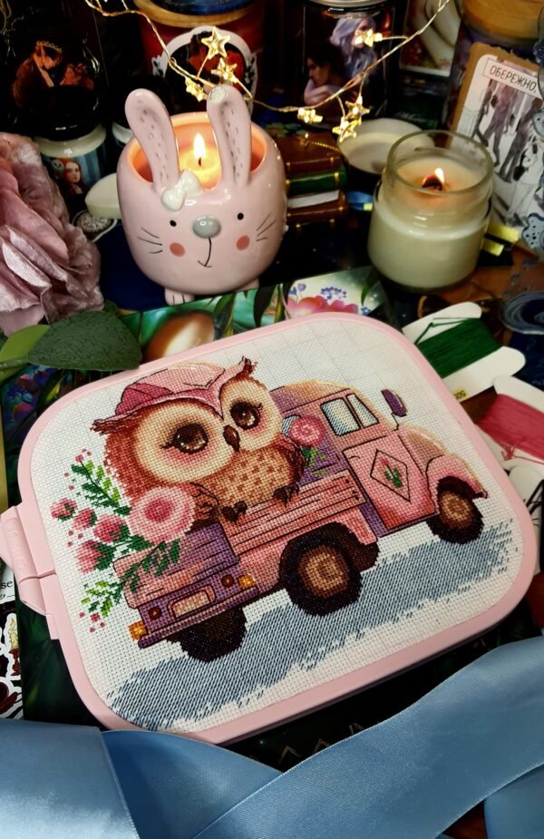 Cute owl on pink truck cross stitch displayed in pink hoop with cozy nursery decor items
