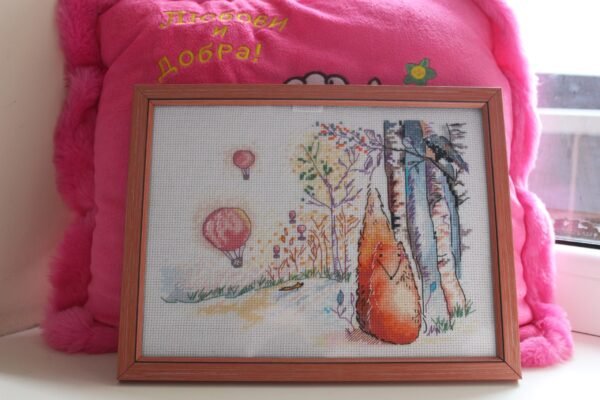 framed fox and raven embroidery with bright trees and balloons