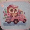 Finished embroidery of baby owl on pink truck design