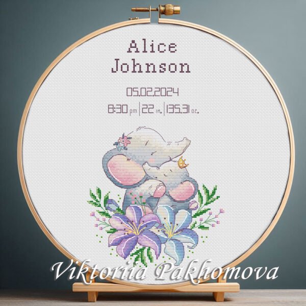 131 Cross stitch embroidery of a personalized elephant birth announcement displayed in a wooden hoop with customizable baby details