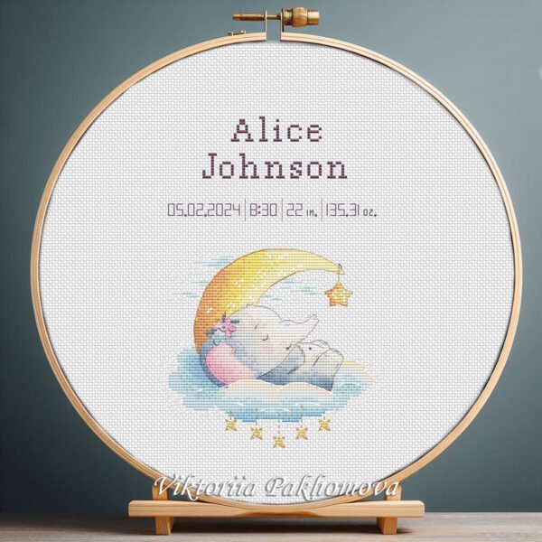 131 Cross stitch embroidery of a personalized baby elephant birth announcement displayed in a wooden hoop with custom newborn details