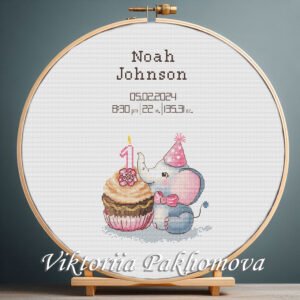 Cross stitch embroidery of a baby elephant 1st birthday design displayed in a wooden hoop with customizable details