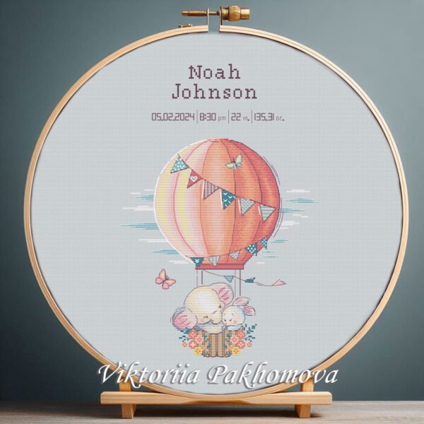 131 Cross stitch embroidery of a personalized elephant and bunny birth announcement displayed in a wooden hoop with custom newborn details
