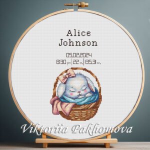 131 Cross stitch embroidery of a personalized baby girl birth announcement with a sleeping bunny displayed in a wooden hoop