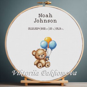 Cross stitch embroidery of a Teddy Bear birth announcement with space for name, date and stats in a wooden hoop
