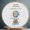 Cross stitch embroidery of a Teddy Bear with a balloon birth announcement with space for name, date and stats in a wooden hoop