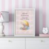 Framed sleeping bunny birth announcement cross stitch featuring personalized name, date and stats for baby girl nursery décor.