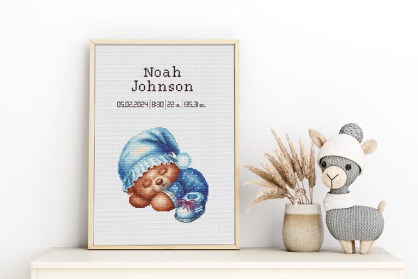 Framed Teddy Bear cross stitch birth announcement with pastel colors and personalized baby details