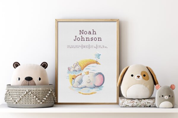 Framed bunny and elephant birth record cross stitch featuring personalized baby name, date and stats for nursery décor.