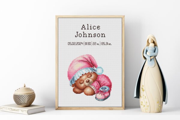 Framed Sleeping Bear cross stitch birth announcement with pastel colors and personalized baby details