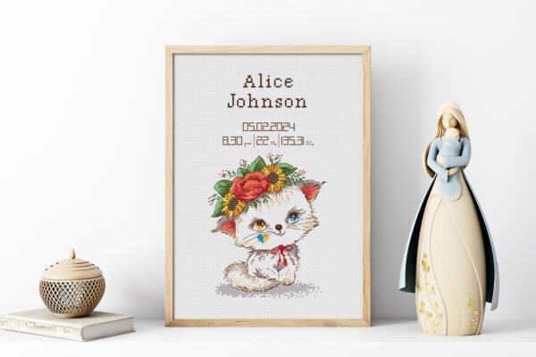 Framed Baby Kitty cross stitch birth announcement with pastel colors and space for personalized baby details