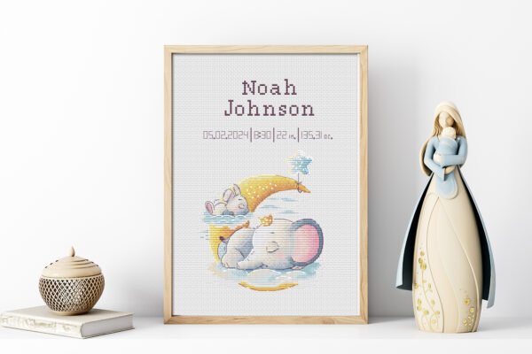 Framed bunny and elephant birth record cross stitch featuring personalized baby name, date and stats for nursery décor.