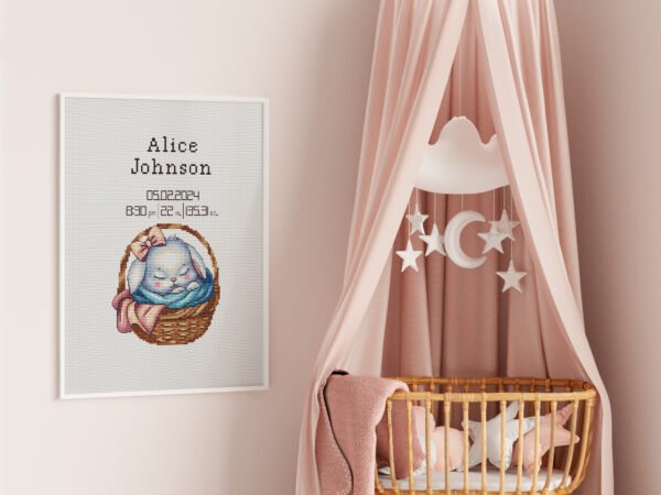 Framed baby girl birth announcement cross stitch featuring a sleeping bunny and personalized newborn details