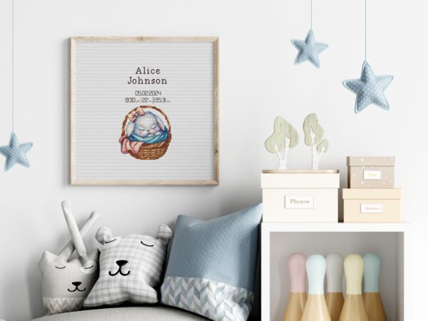 Framed baby girl birth announcement cross stitch featuring a sleeping bunny and personalized newborn details