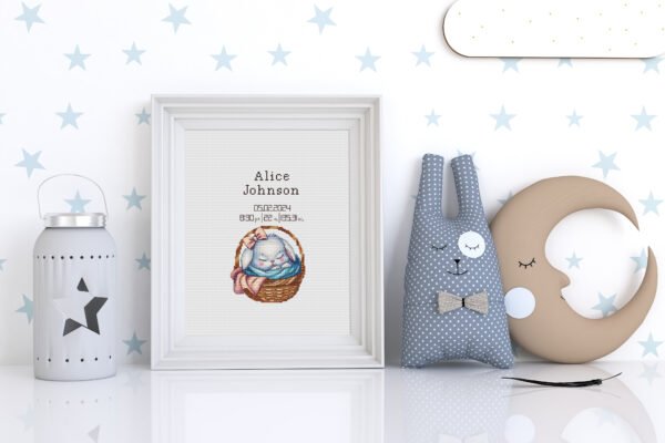 Framed baby girl birth announcement cross stitch featuring a sleeping bunny and personalized newborn details