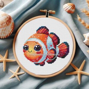 Cute baby clown fish cross stitch pattern in colorful ocean tones inside embroidery hoop