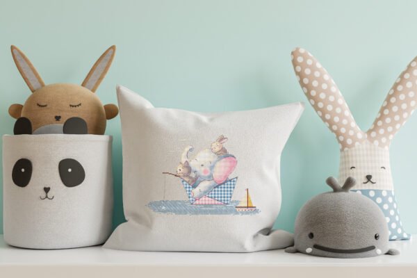 Nursery pillow featuring a cross stitch design of an elephant, a bunny and a cat sailing in a paper boat with gentle pastel colors.