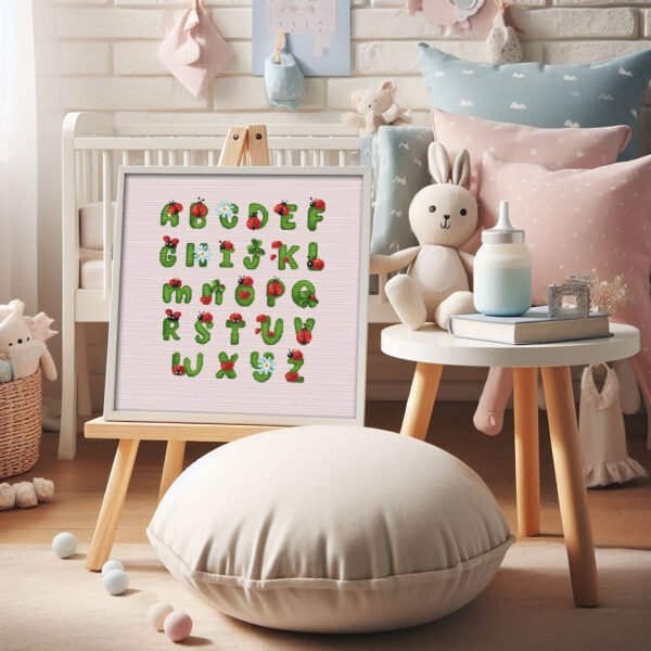 Framed cross stitch of a ladybug alphabet featuring cute insect‑style letters for nursery décor