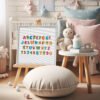 Framed cross stitch of a dinosaur alphabet featuring bright rainbow Jurassic letters for nursery décor.