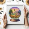 42 Framed cross stitch artwork featuring a sunflower landscape inside a glass ball with a cozy house and bright summer colors