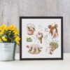 Framed spring sampler cross stitch featuring magic ice cream, coffee cup, floral boots, bouquet and a cute girl with “time to dream” text.
