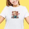 cross stitch of a woodland bear reading a book with cozy floral accents on t-shirt